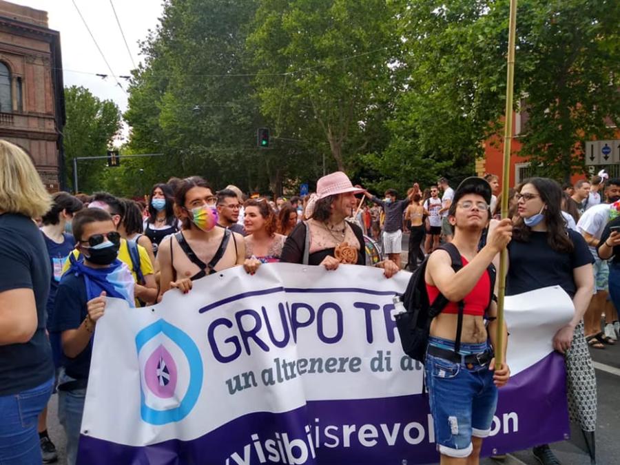Gruppo Trans members marching behind their banner at a Pride in Bologna